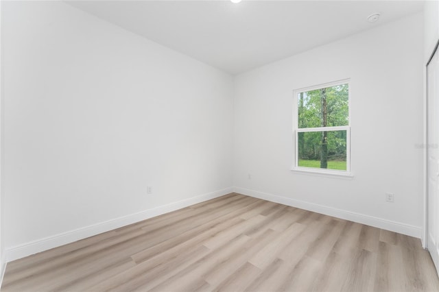 9312 N Akola Way, Citrus Springs, FL 34434 - empty room with light wood finished floors and a smoke detector