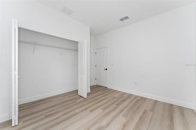 9312 N Akola Way, Citrus Springs, FL 34434 - unfurnished bedroom featuring light wood-style floors and a closet