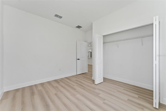 9312 N Akola Way, Citrus Springs, FL 34434 - unfurnished bedroom with light wood-style floors and a closet