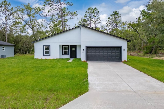 9312 N Akola Way, Citrus Springs, FL 34434 - modern home featuring driveway, an attached garage, a front lawn, and stucco siding