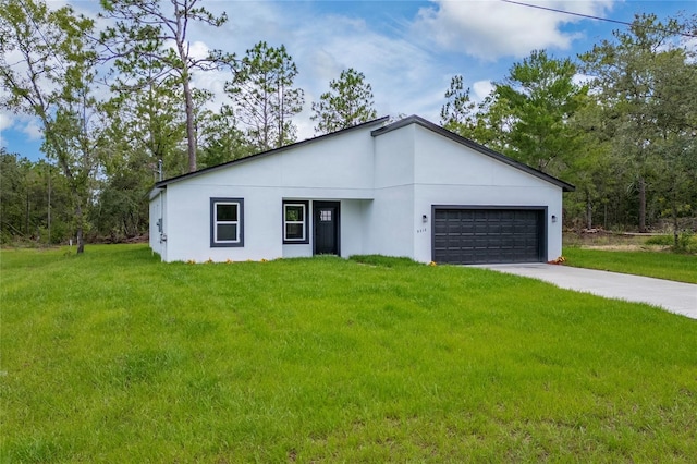9312 N Akola Way, Citrus Springs, FL 34434 - modern home with an attached garage, a front yard, concrete driveway, and stucco siding