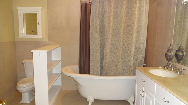 1144 Delaney Ave Unit 1144, Orlando, FL 32806 - bathroom featuring tile walls, a freestanding tub, and vanity