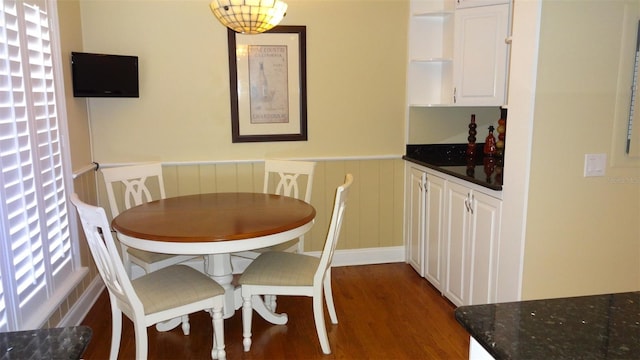 1144 Delaney Ave Unit 1144, Orlando, FL 32806 - dining area with wood finished floors, wainscoting, and a decorative wall