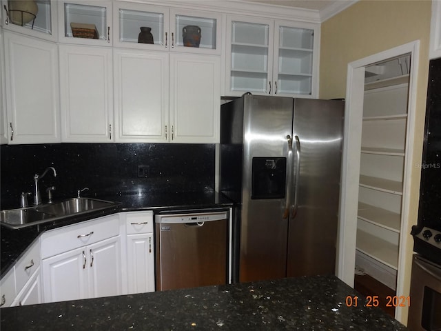 1144 Delaney Ave Unit 1144, Orlando, FL 32806 - kitchen featuring stainless steel appliances, white cabinets, dark stone counters, tasteful backsplash, and ornamental molding
