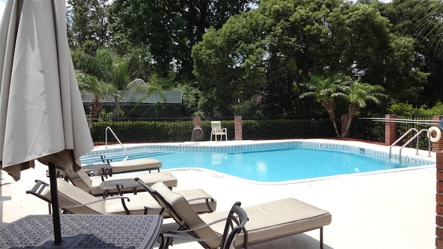 1144 Delaney Ave Unit 1144, Orlando, FL 32806 - community pool featuring a patio area and view of scattered trees