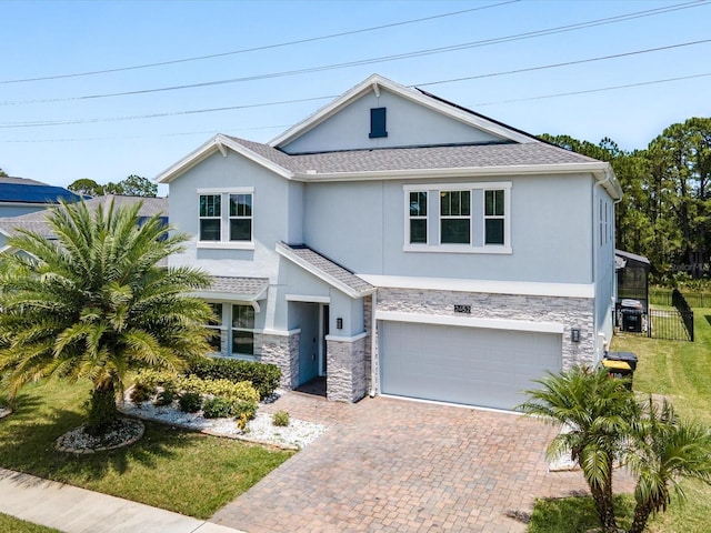 2452 Camden Park Ave, Davenport, FL 33837 - view of front of home with stucco siding, stone siding, decorative driveway, a garage, and a front lawn