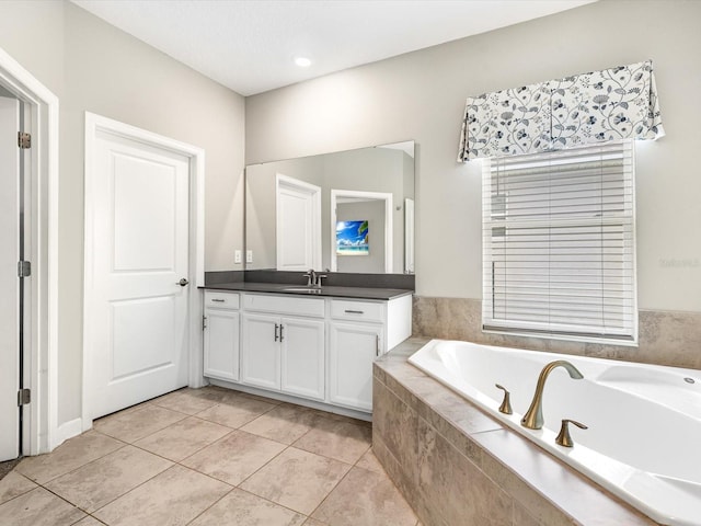 2452 Camden Park Ave, Davenport, FL 33837 - bathroom with vanity, a bath, and tile patterned floors