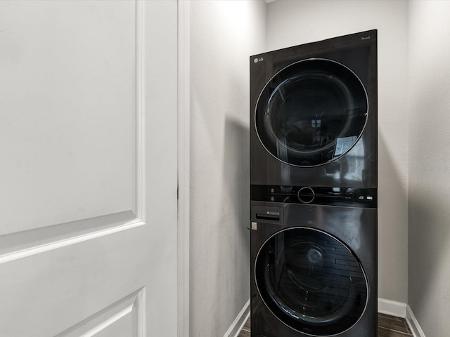 2452 Camden Park Ave, Davenport, FL 33837 - laundry area featuring stacked washer / drying machine and dark wood-style flooring