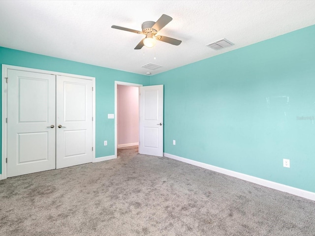 2452 Camden Park Ave, Davenport, FL 33837 - unfurnished bedroom with carpet, a closet, and a ceiling fan