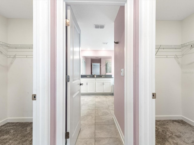 2452 Camden Park Ave, Davenport, FL 33837 - hallway featuring light carpet and light tile patterned floors
