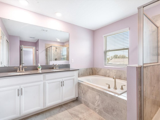2452 Camden Park Ave, Davenport, FL 33837 - bathroom with double vanity, a stall shower, and a bath