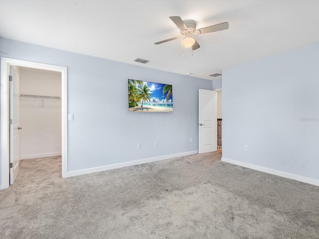2452 Camden Park Ave, Davenport, FL 33837 - unfurnished bedroom with carpet floors, a spacious closet, and ceiling fan