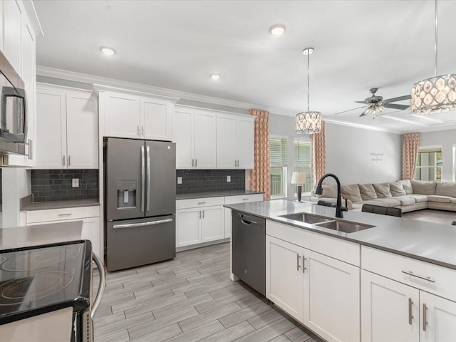 2452 Camden Park Ave, Davenport, FL 33837 - kitchen featuring stainless steel appliances, white cabinets, a ceiling fan, backsplash, and decorative light fixtures