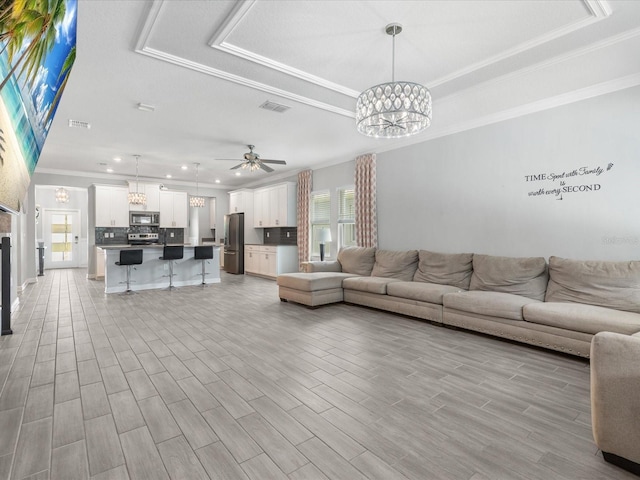 2452 Camden Park Ave, Davenport, FL 33837 - living area featuring a chandelier, crown molding, ceiling fan, light wood-type flooring, and recessed lighting