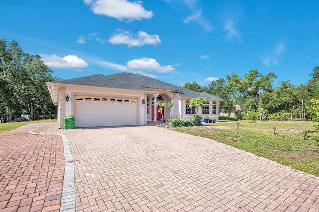 18852 Starry St, Orlando, FL 32833 - ranch-style house featuring decorative driveway, an attached garage, and a front lawn