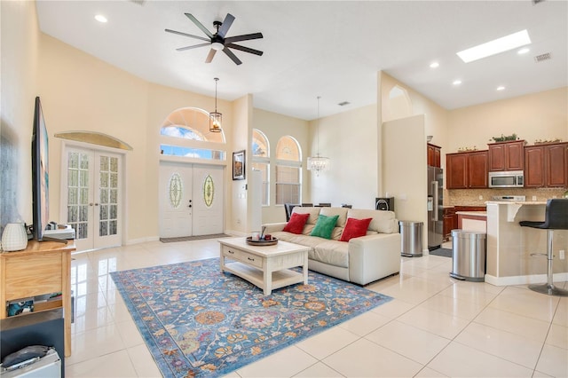 18852 Starry St, Orlando, FL 32833 - living room with a high ceiling, ceiling fan, light tile patterned floors, recessed lighting, and french doors