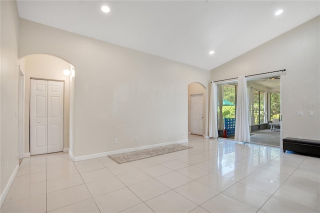 18852 Starry St, Orlando, FL 32833 - spare room featuring arched walkways, light tile patterned floors, recessed lighting, and high vaulted ceiling