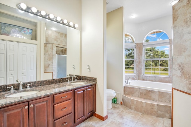 18852 Starry St, Orlando, FL 32833 - full bathroom featuring double vanity, a bath, a shower with shower door, and tile patterned flooring