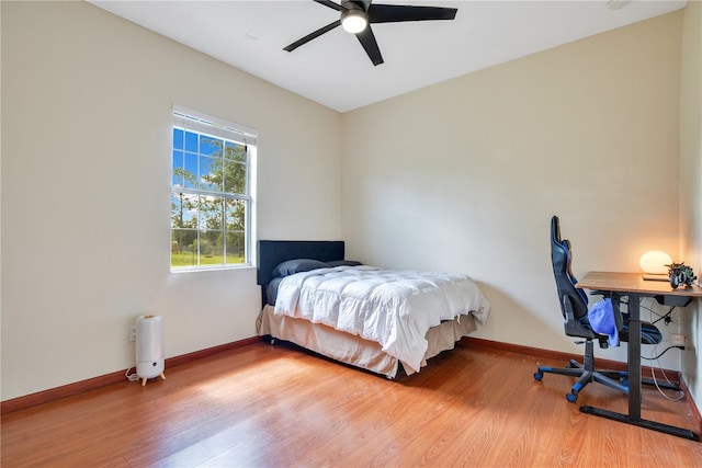 18852 Starry St, Orlando, FL 32833 - bedroom with wood finished floors, a ceiling fan, and a desk