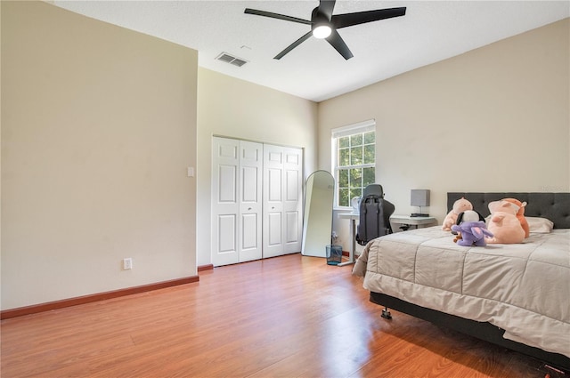 18852 Starry St, Orlando, FL 32833 - bedroom with light wood-style flooring, a closet, and a ceiling fan