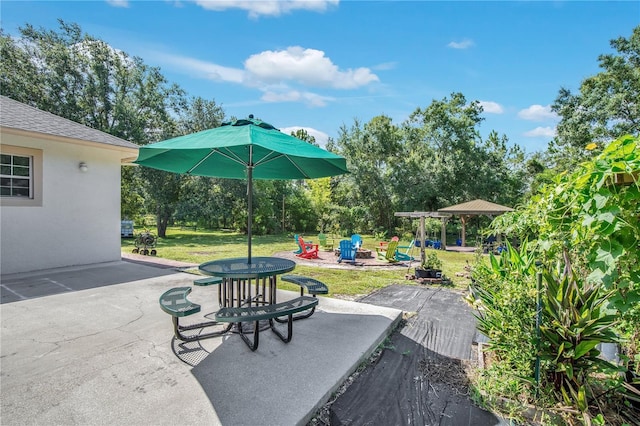18852 Starry St, Orlando, FL 32833 - view of patio / terrace with a fire pit and view of wooded area