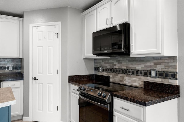 2885 Lafayette Trace Dr, Saint Cloud, FL 34772 - kitchen with black microwave, electric stove, decorative backsplash, and white cabinetry