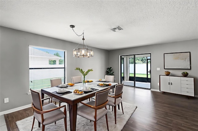 2885 Lafayette Trace Dr, Saint Cloud, FL 34772 - dining room featuring a textured ceiling, a chandelier, and dark wood-style floors