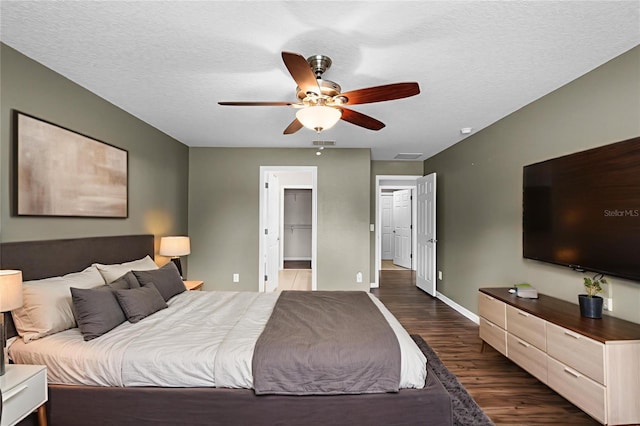 2885 Lafayette Trace Dr, Saint Cloud, FL 34772 - bedroom with dark wood-style floors, a ceiling fan, and a textured ceiling