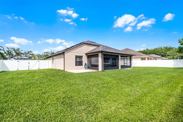 2885 Lafayette Trace Dr, Saint Cloud, FL 34772 - back of property featuring a sunroom, a fenced backyard, stucco siding, and a gate