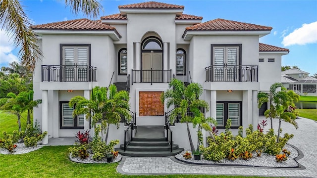 1329 Jumana Loop, Apollo Beach, FL 33572 - view of front of home featuring french doors, a balcony, and stucco siding