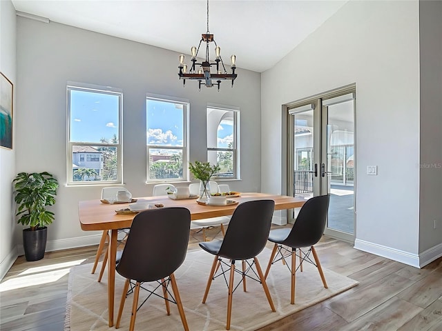1329 Jumana Loop, Apollo Beach, FL 33572 - dining room featuring a chandelier, french doors, light wood-type flooring, and lofted ceiling