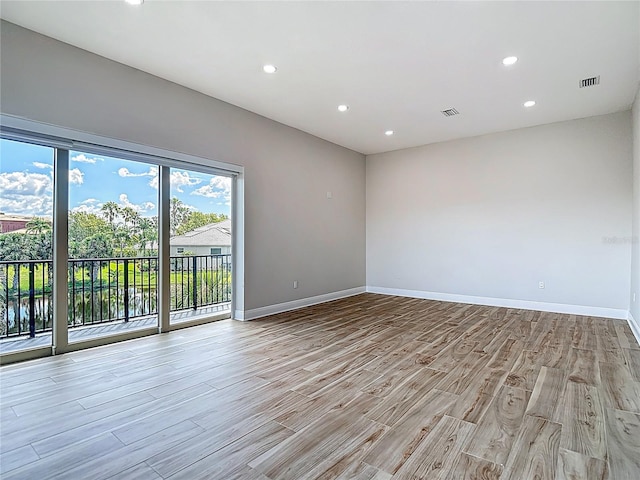 1329 Jumana Loop, Apollo Beach, FL 33572 - empty room featuring light wood finished floors and recessed lighting