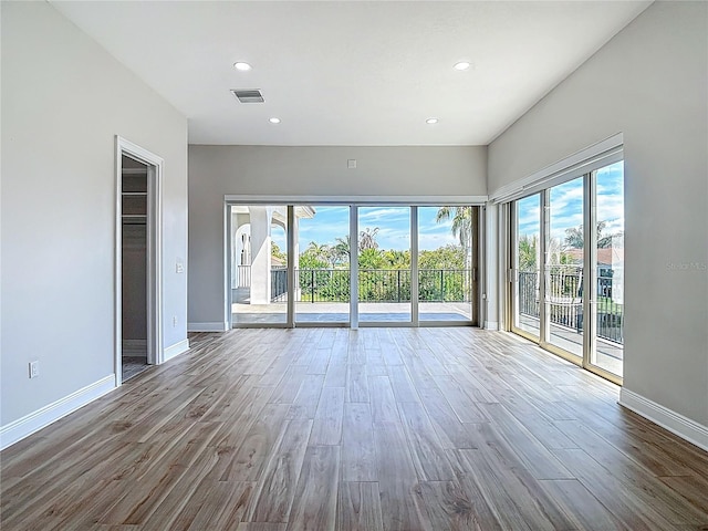 1329 Jumana Loop, Apollo Beach, FL 33572 - unfurnished room featuring healthy amount of natural light, wood finished floors, and recessed lighting