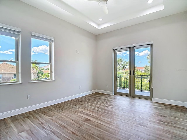 1329 Jumana Loop, Apollo Beach, FL 33572 - spare room featuring wood finished floors, french doors, recessed lighting, and a raised ceiling