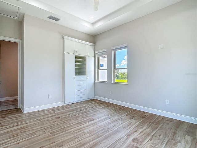 1329 Jumana Loop, Apollo Beach, FL 33572 - unfurnished bedroom with light wood finished floors, a closet, recessed lighting, and a ceiling fan