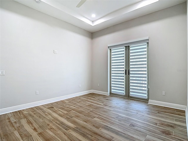 1329 Jumana Loop, Apollo Beach, FL 33572 - empty room with wood finished floors, a tray ceiling, and recessed lighting