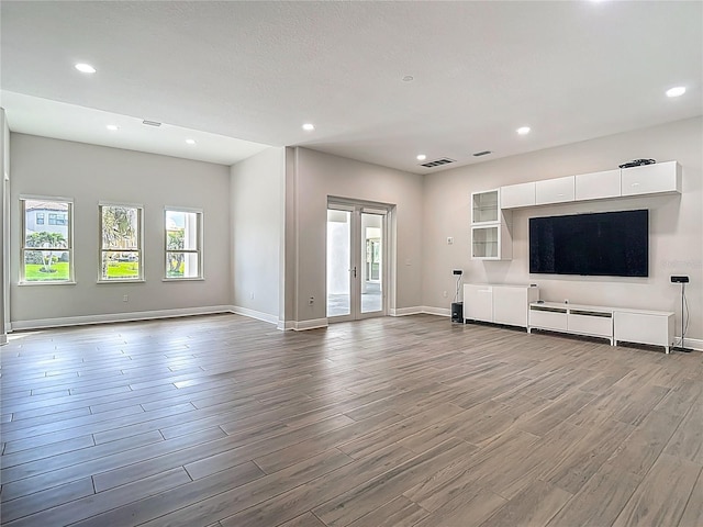 1329 Jumana Loop, Apollo Beach, FL 33572 - unfurnished living room with wood finished floors and recessed lighting