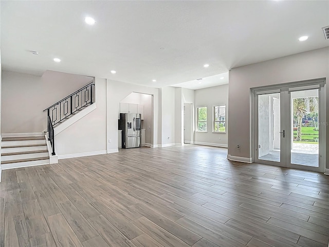 1329 Jumana Loop, Apollo Beach, FL 33572 - unfurnished living room featuring wood finished floors, stairway, recessed lighting, and arched walkways