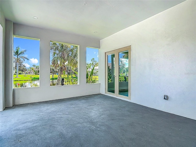 1329 Jumana Loop, Apollo Beach, FL 33572 - empty room with unfinished concrete flooring and plenty of natural light