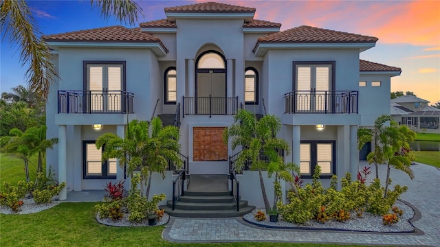1329 Jumana Loop, Apollo Beach, FL 33572 - view of front of house featuring french doors, a balcony, and stucco siding