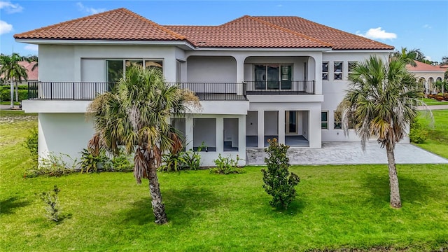 1329 Jumana Loop, Apollo Beach, FL 33572 - rear view of house featuring a balcony, stucco siding, and a lawn