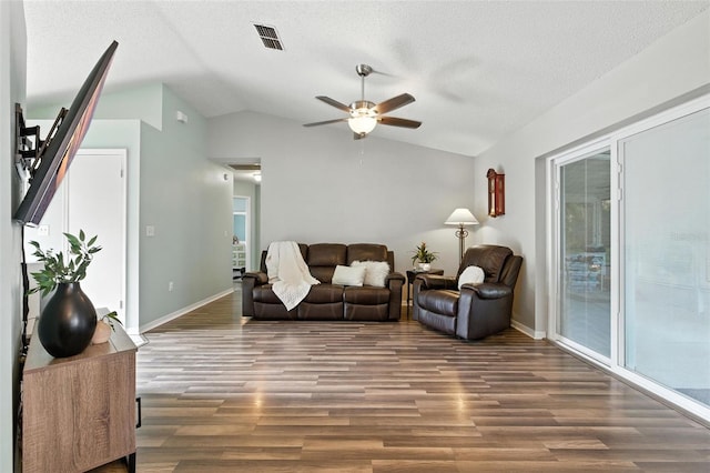 2212 Clementine Trl, Clermont, FL 34714 - living room featuring a ceiling fan, lofted ceiling, wood finished floors, and a textured ceiling