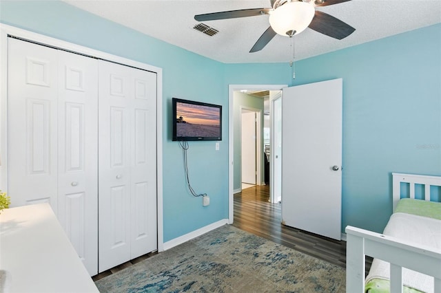 2212 Clementine Trl, Clermont, FL 34714 - bedroom with wood finished floors, a closet, and a ceiling fan