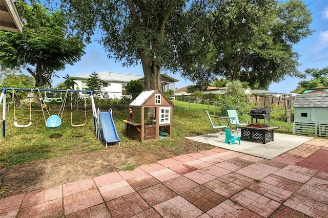2212 Clementine Trl, Clermont, FL 34714 - view of patio / terrace featuring a playground, a fire pit, and area for grilling