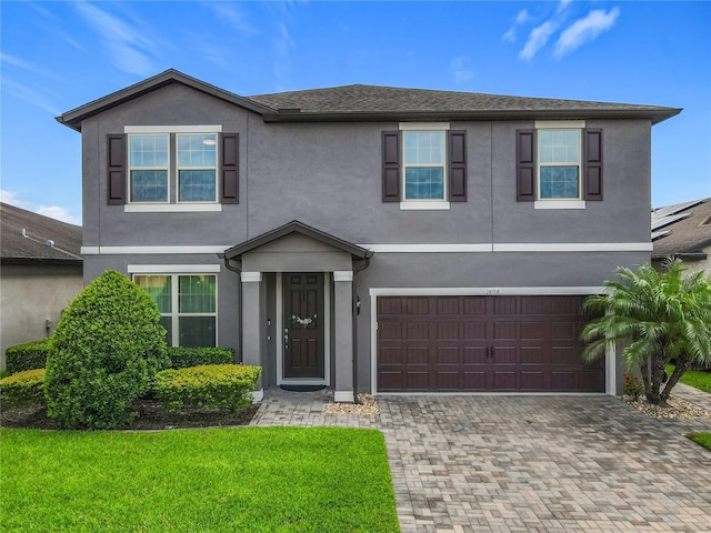 1808 Regal River Cir, Ocoee, FL 34761 - view of front of property with stucco siding, an attached garage, decorative driveway, and a front lawn