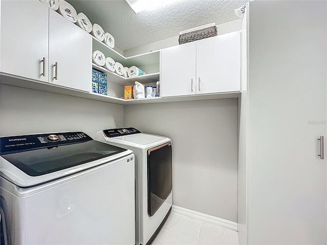 1808 Regal River Cir, Ocoee, FL 34761 - washroom featuring cabinet space, washer and dryer, a textured ceiling, and light tile patterned flooring