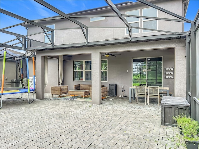 1808 Regal River Cir, Ocoee, FL 34761 - view of patio / terrace with a trampoline, outdoor dining area, a ceiling fan, an outdoor hangout area, and glass enclosure