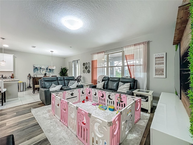 1808 Regal River Cir, Ocoee, FL 34761 - living room featuring a textured ceiling and light wood-style floors