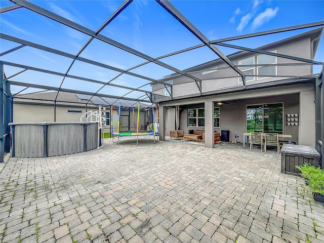 1808 Regal River Cir, Ocoee, FL 34761 - view of patio with a trampoline, ceiling fan, outdoor dining space, an outdoor living space, and a lanai