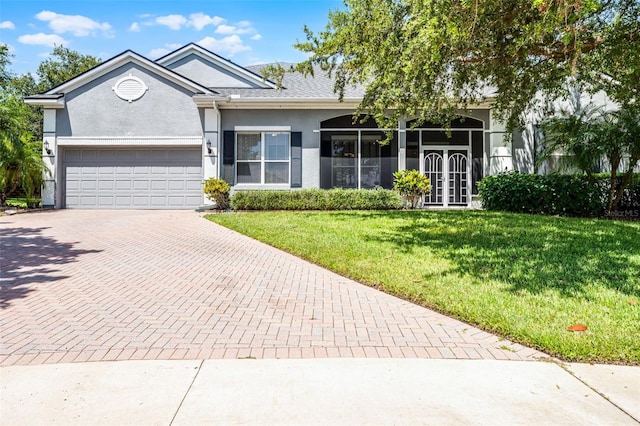 2495 Squaw Crk, Clermont, FL 34711 - single story home featuring decorative driveway, stucco siding, an attached garage, a front yard, and french doors